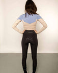 The behind of a blue and beige base layer with black leggings.