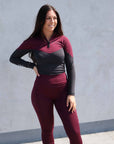 Bruntette model wearing burgundy and grey equestrian riding clothes