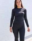 Brunette model wearing long sleeve equestrian lycra base layer top