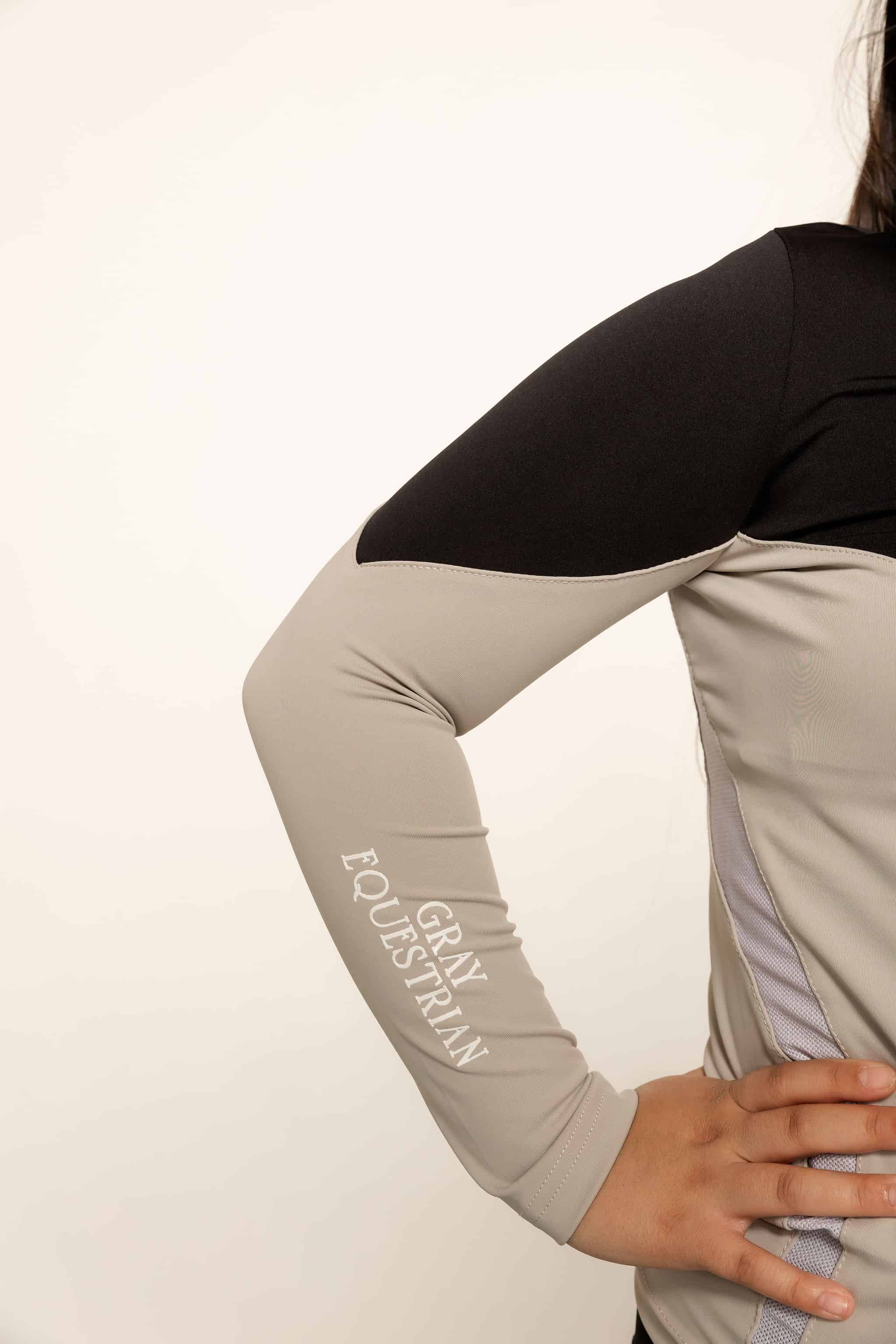 Our child model wearing our black and grey two toned base layer and black riding leggings.