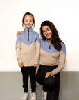 Young rider and adult model wearing beige and blue base layer and riding leggings