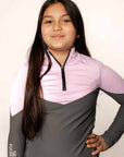 Young rider wearing lilac and grey base layer
