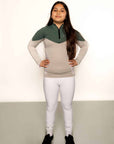 Young rider children white competition leggings whilst riding.