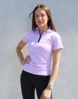Brunette model wearing lilac base layer with black leggings