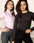 Brunette model wearing long sleeve equestrian lycra base layer top with model wearing lilac base layer and grey leggings