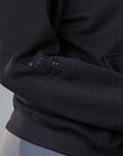 A close up of the gloss Grey Equestrian branding on the sleeve.