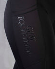 Close up on the Grey Equestrian detail on our black leggings.
