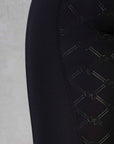 a close up of the black GE detailing on the back of the leggings.