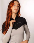 Red haired model wearing our long-sleeved black and grey two toned base layer.