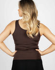 A blonde model wearing our brown scoop neck equestrian vest in a tight-fitting breathable fabric.