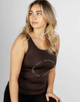 A blonde model wearing our brown scoop neck equestrian vest in a tight-fitting breathable fabric.