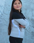 Our child model wearing our black and grey two toned base layer and black riding leggings.