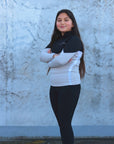 Our child model wearing our black and grey two toned base layer and black riding leggings.