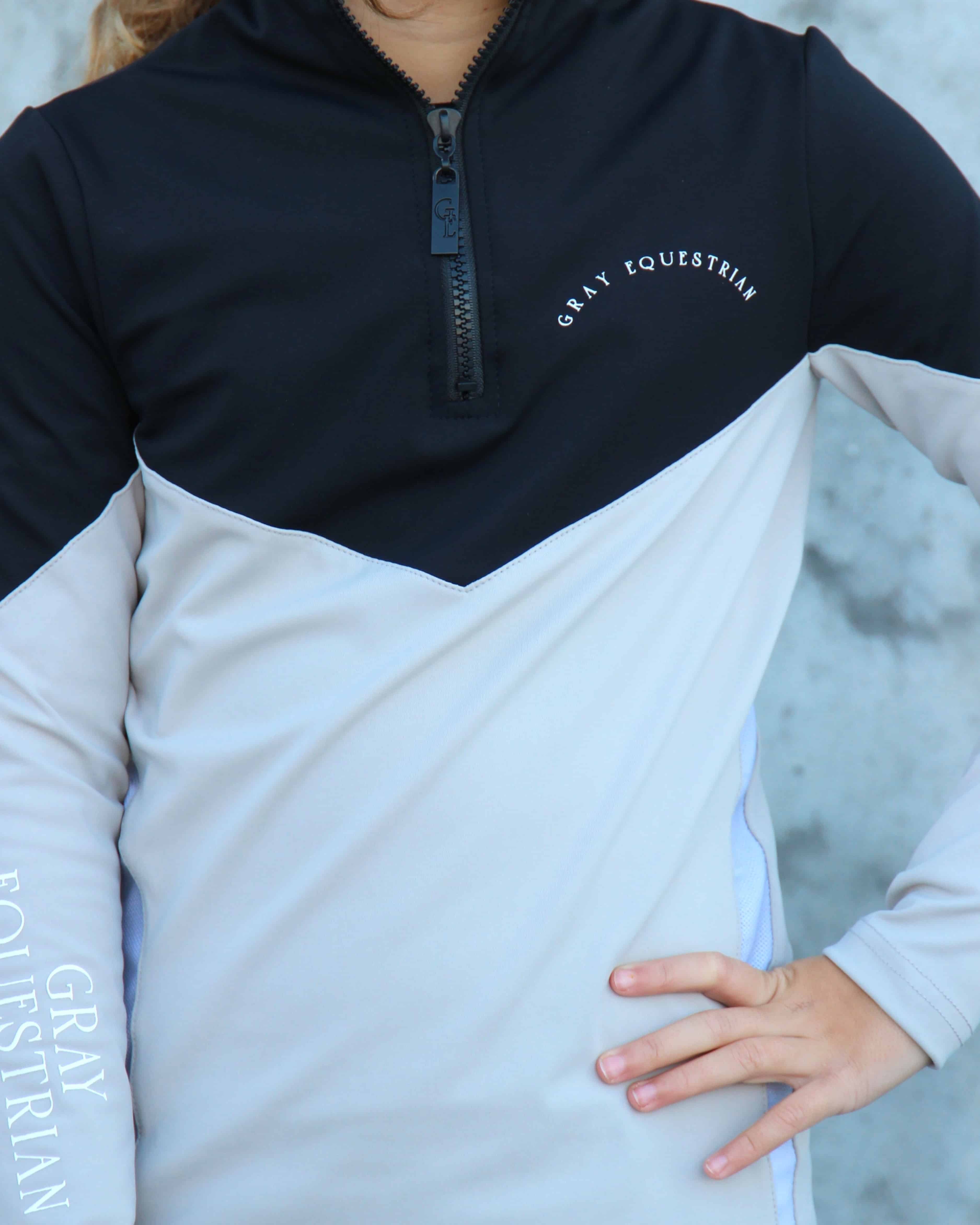 Our child model wearing our black and grey two toned base layer.
