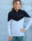 Our child model wearing our black and grey two toned base layer and green riding leggings.