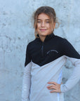 Our child model wearing our black and grey two toned base layer.