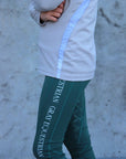 A child model wearing our green renew riding leggings.