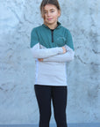 A child model wearing our our green and grey base layer with black leggings.