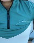 A child model wearing our our green and grey base layer with black leggings.