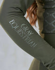 A close up of the subtle Gray Equestrian branding on the sleeve of our base layer.