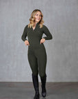 A blonde model wearing our fleece lined long sleeve khaki base layer and matching khaki riding leggings.