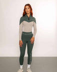 A model wearing our green and grey two toned base layer and matching green riding leggings.