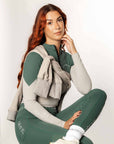 A model wearing our green and grey two toned base layer and matching green riding leggings.