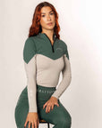 A model wearing our green and grey two toned base layer and matching green riding leggings.