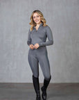 A blonde model wearing our long sleeved grey two toned base layer with matching riding leggings.
