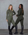 Two models standing side by side. The model on the left is wearing our khaki base layer and leggings. The model on the right is wearing our green base layer and leggings.