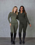 Two models standing side by side. The model on the left is wearing our khaki base layer and leggings. The model on the right is wearing our green base layer and leggings.