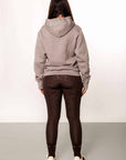 A model wearing our taupe grey hoodie and brown riding leggings.