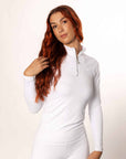 A model wearing our white long sleeved base layer and matching riding leggings.