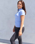 A model wearing our short sleeved light blue base layer and black riding leggings.