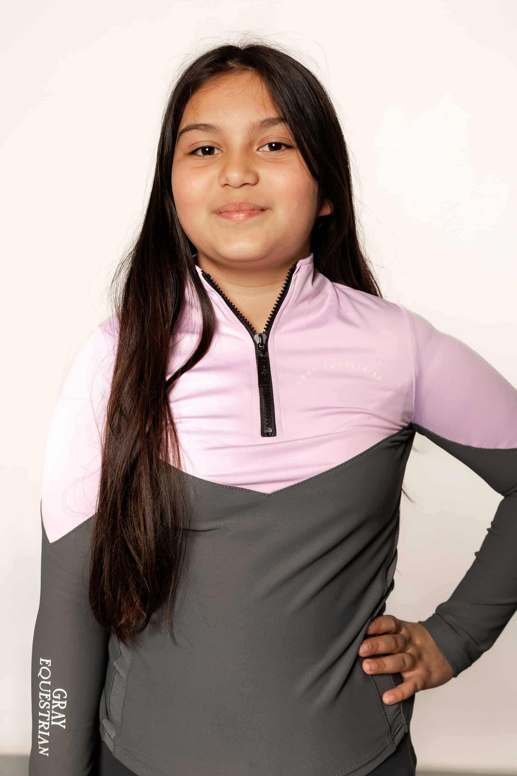 Young rider wearing lilac and grey base layer