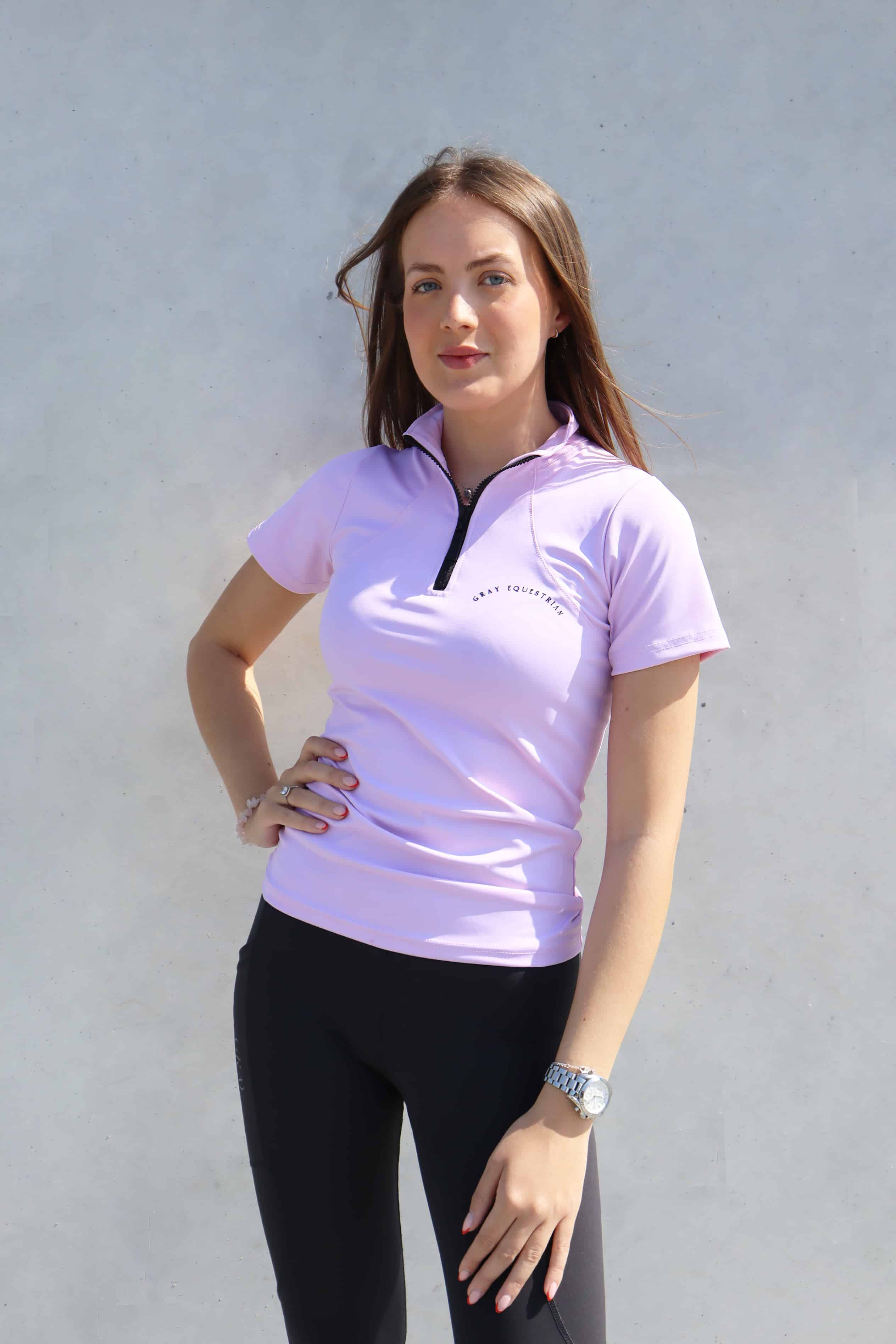 Brunette model wearing lilac base layer with black leggings