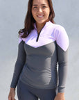 Equestrian rider  wearing the lilac and grey base layer top and grey leggings