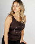 A blonde model wearing our brown scoop neck equestrian vest in a tight-fitting breathable fabric.