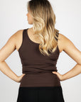 A blonde model wearing our brown scoop neck equestrian vest in a tight-fitting breathable fabric.