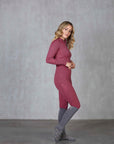 A blonde model wearing our fleece-lined berry leggings with matching long-sleeved 1/4 zip base layer.