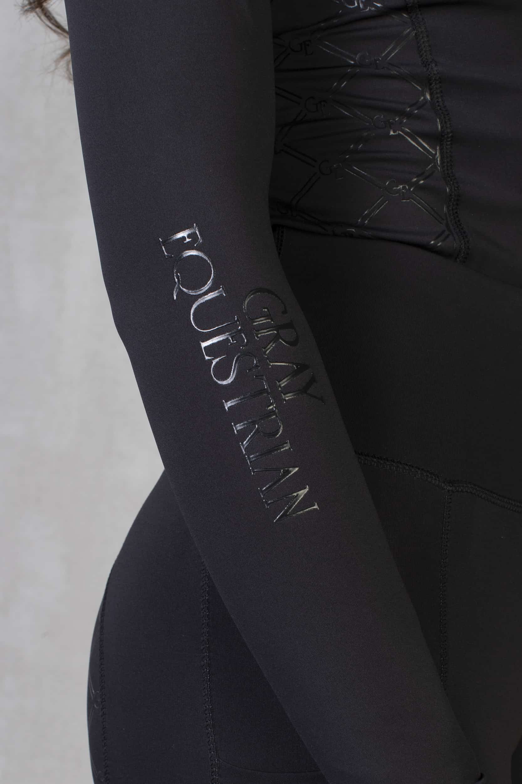 A close up of our long sleeve with black Grey Equestrian detailing.