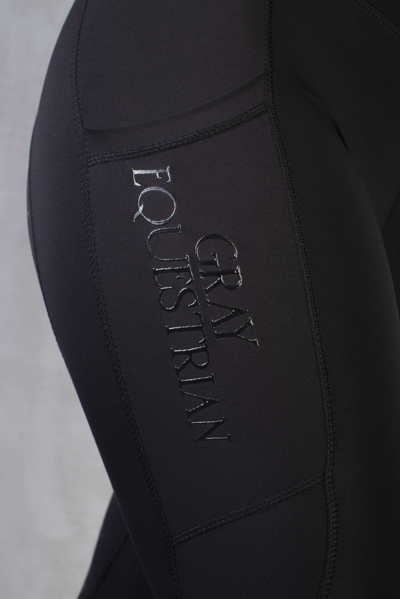Close up on the Grey Equestrian detail on our black leggings.