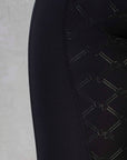 a close up of the black GE detailing on the back of the leggings.
