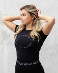 Blonde model wearing our black scoop neck tight fitting black riding t-shirt.