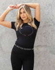 A blonde model wearing our black scoop neck tight fitting black riding t-shirt.