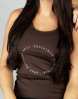 A brunette model wearing our brown scoop neck equestrian vest in a tight-fitting breathable fabric.