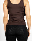 A brunette model wearing our brown scoop neck equestrian vest in a tight-fitting breathable fabric.