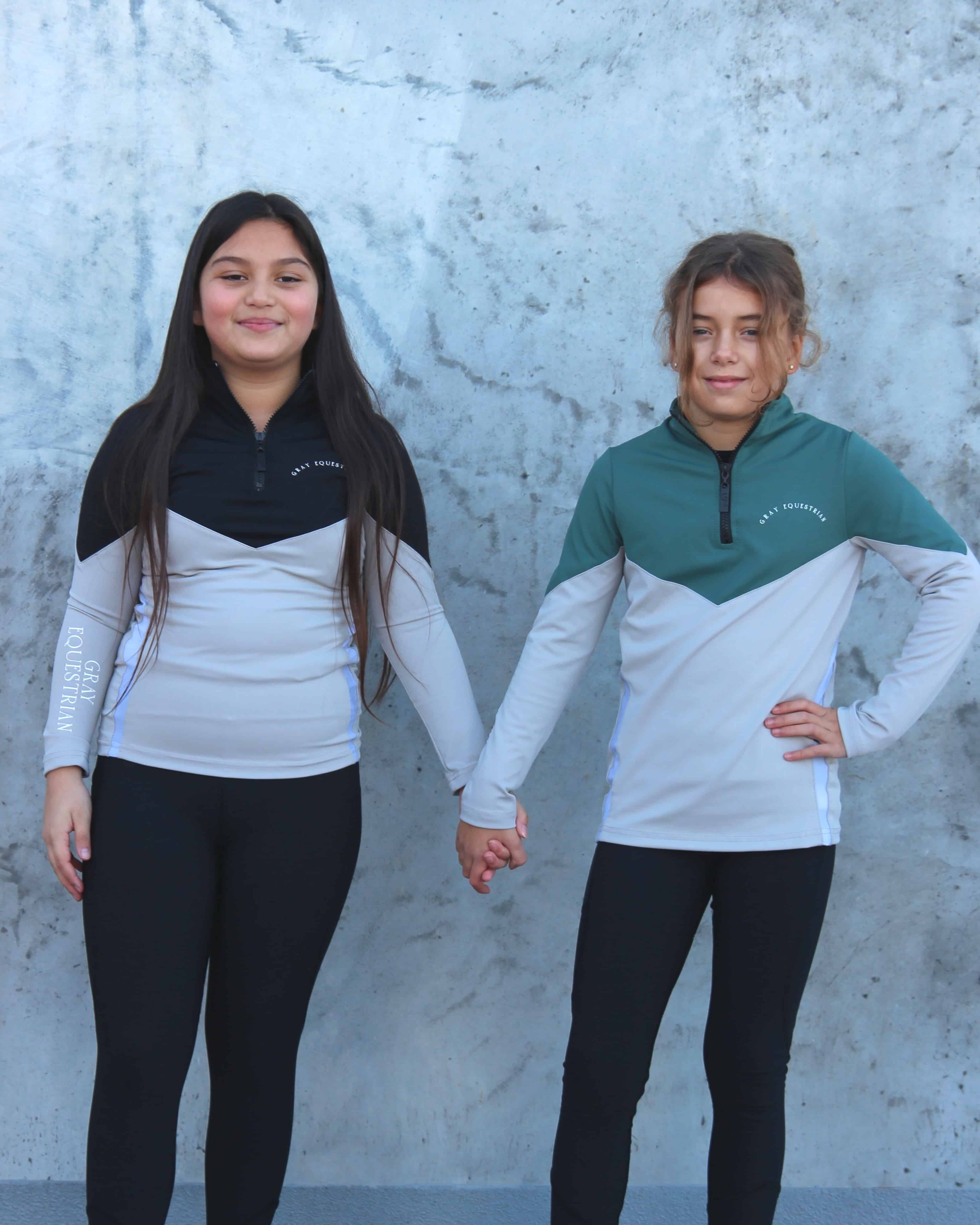 A child models wearing our black fleece lined riding leggings.