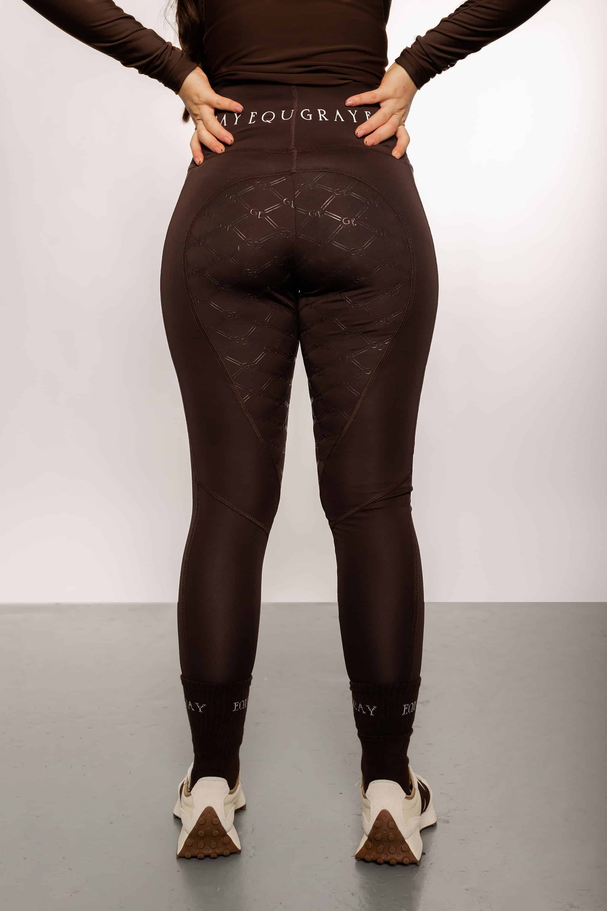 A view of the back of our brown fleece lined riding leggings with full non-slip seat.