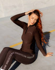 A model wearing our fleece lined 1/4 zip base layer and matching riding leggings.